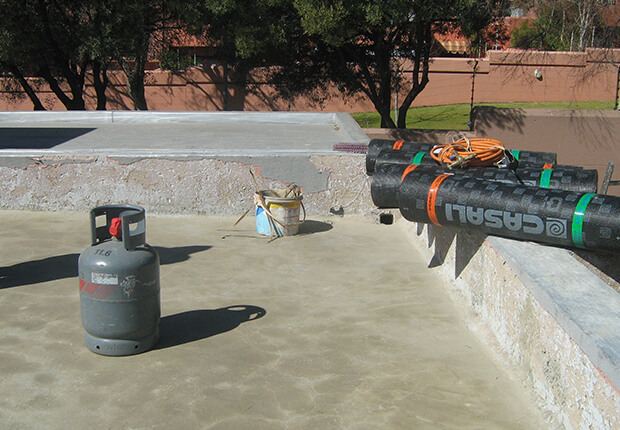 Torch-on membrane application on concrete roof surface