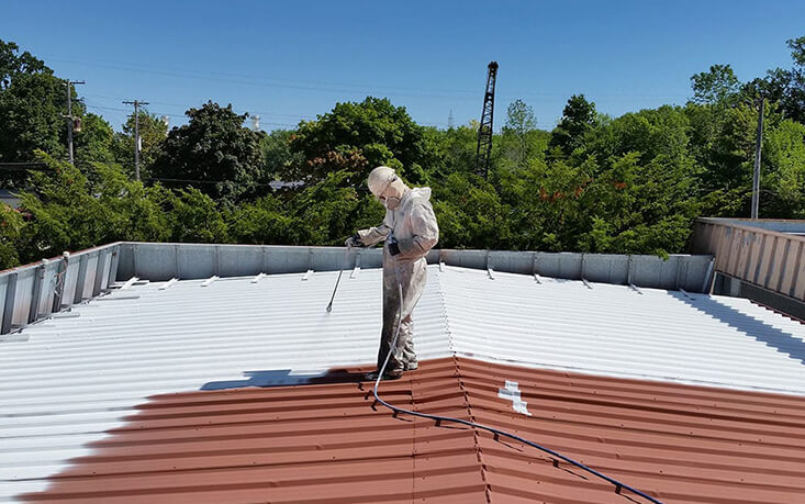 Professional roof coating application on residential property